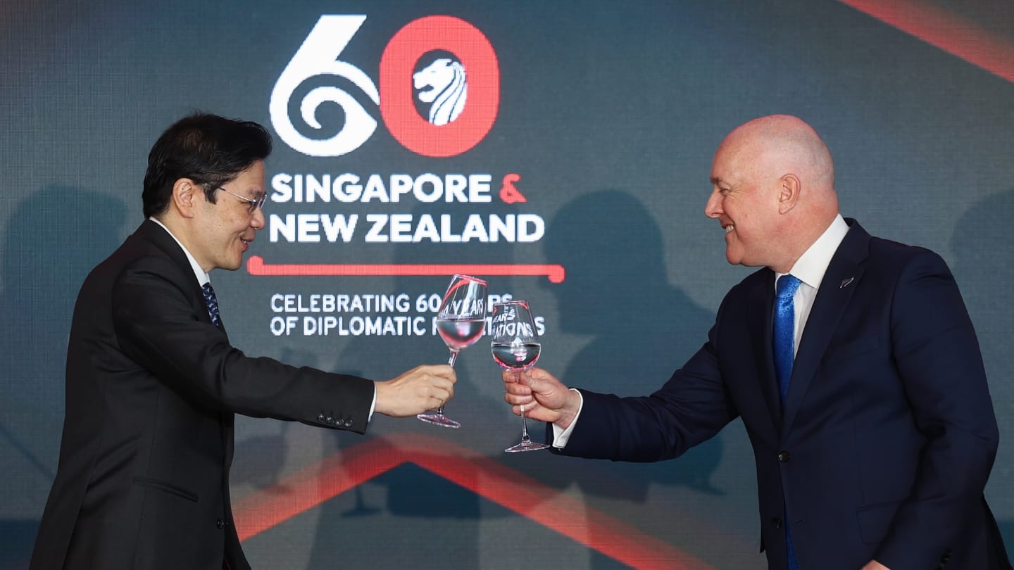 Two men clinking wine glasses.